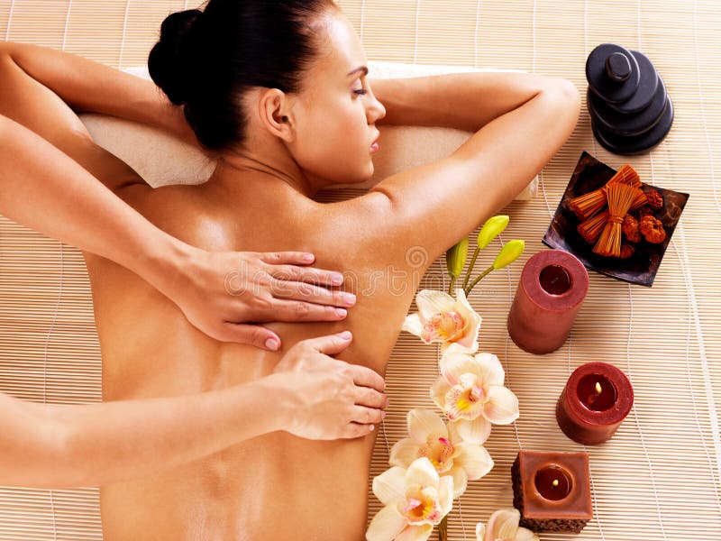 Adult woman in spa salon having body relaxing massage. Adult woman in spa salon having body relaxing massage.