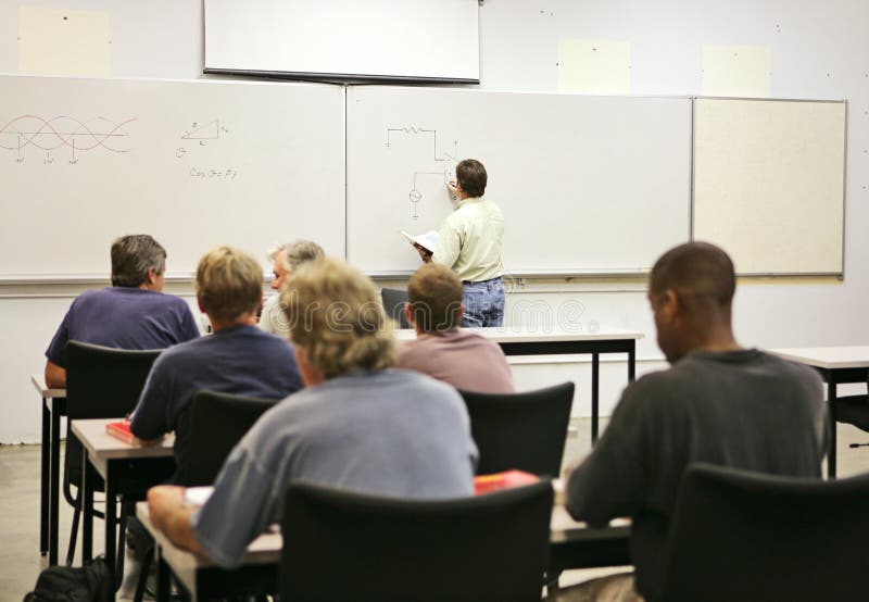 An adult education teacher in front of his class, drawing a diagram on the board. Focus on teacher and diagrams. FILE ID: 2721612. An adult education teacher in front of his class, drawing a diagram on the board. Focus on teacher and diagrams. FILE ID: 2721612