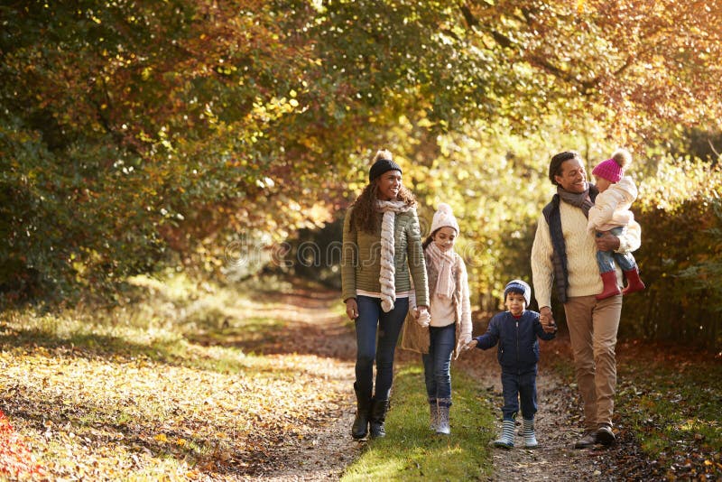 Front View Of Family Enjoying Autumn Walk In Countryside. Front View Of Family Enjoying Autumn Walk In Countryside