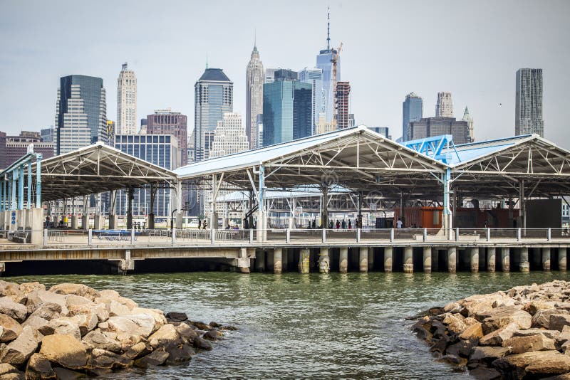 New York CIty, USA - July 7, 2018; View of pier 2 in Brooklyn with unrecognizable people playing basketball during summer daytime on July 7, 2018 in New York CIty. New York CIty, USA - July 7, 2018; View of pier 2 in Brooklyn with unrecognizable people playing basketball during summer daytime on July 7, 2018 in New York CIty