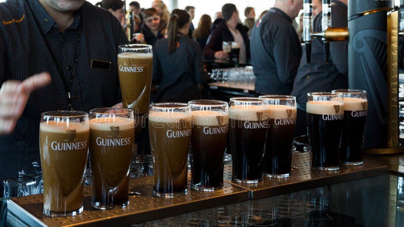 DUBLIN, IRELAND - FEB 15, 2014: Pints of beer are served at the Guinness Brewery. The brewery where 2.5 million pints of stout are brewed daily was founded by Arthur Guinness in 1759. DUBLIN, IRELAND - FEB 15, 2014: Pints of beer are served at the Guinness Brewery. The brewery where 2.5 million pints of stout are brewed daily was founded by Arthur Guinness in 1759.