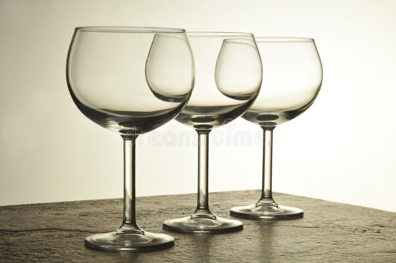 Three Overlapping Empty Wine Glasses with warm side light. Three Overlapping Empty Wine Glasses with warm side light