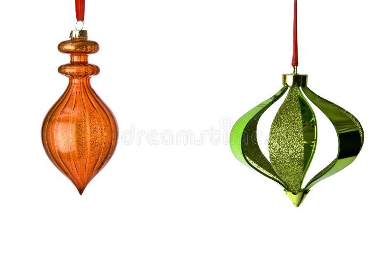 Decorative Christmas Tree Ornaments hanging from red ribbons isolated on white background with clipping path. Lots of room for copy. Decorative Christmas Tree Ornaments hanging from red ribbons isolated on white background with clipping path. Lots of room for copy.