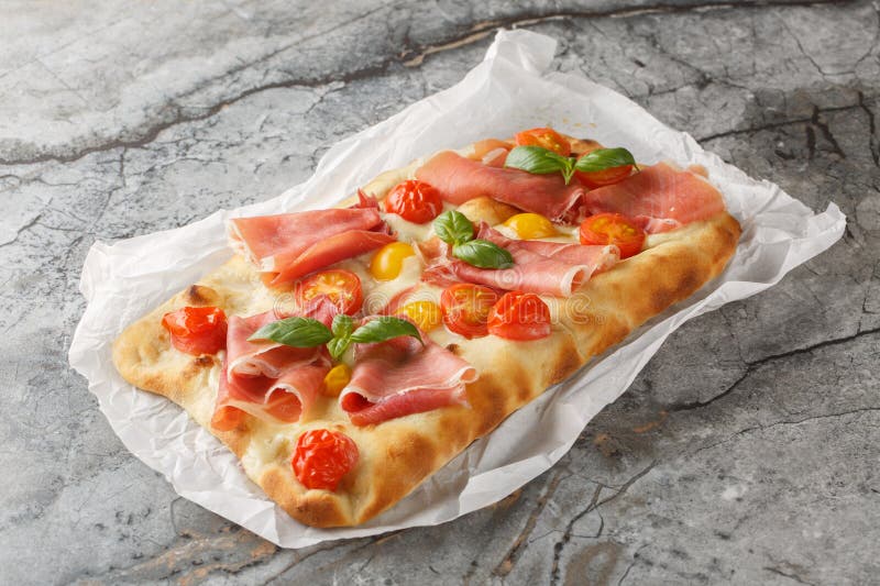 Вкусная пицца pinsa romana с томатной смесью сыра моцарелла и базилик на пергаменте. по горизонтали стоковые изображения rf