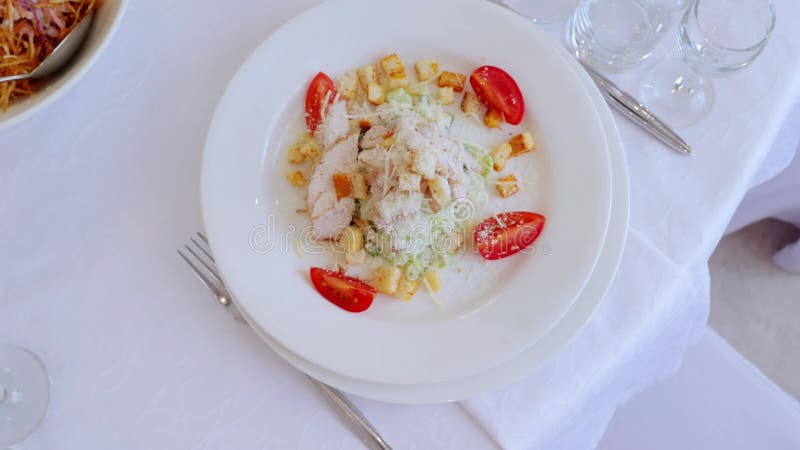 вкусный салат из цезара с курицей на гриле, сыр пармезан и помидоры черри на белой тарелке сток-видео