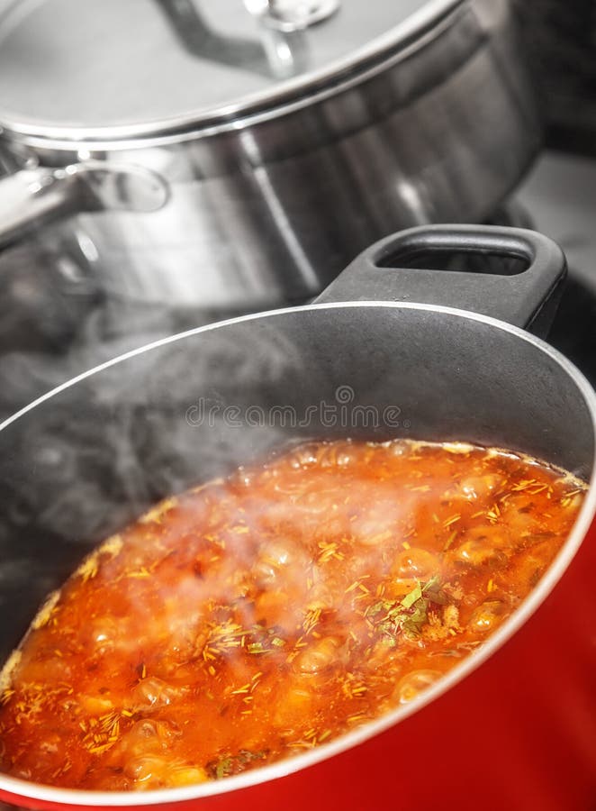 Closeup of tasty red boiling ukrainian borsch in pan on the cooker, homemade delicious food, healthy tomato soup. Closeup of tasty red boiling ukrainian borsch in pan on the cooker, homemade delicious food, healthy tomato soup