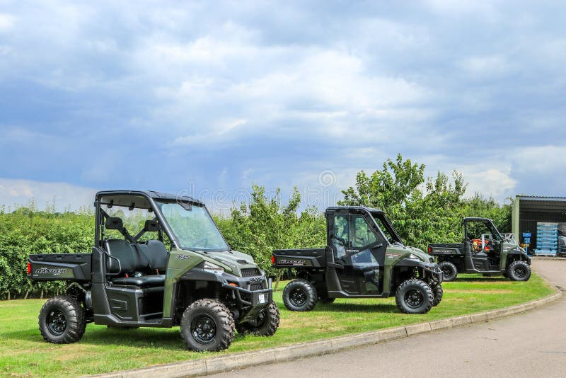 Three army green Polaris ADC ranger utility vehicles. Three army green Polaris ADC ranger utility vehicles