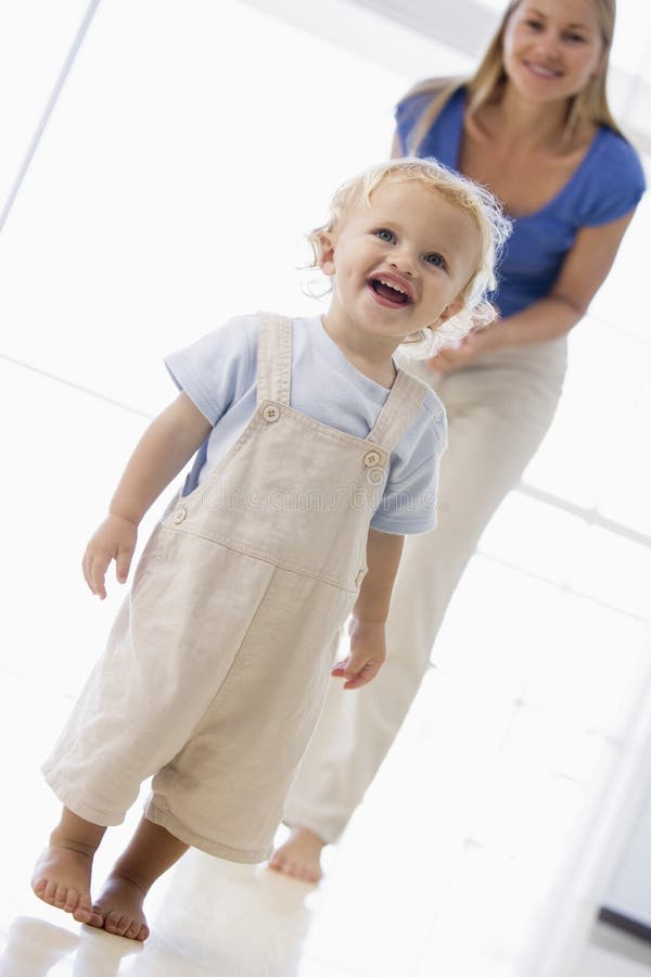 Mother and son indoors smiling at camera. Mother and son indoors smiling at camera