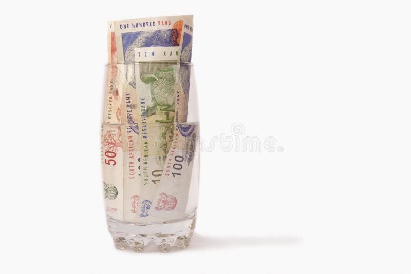 South African money (360 Rands) in a glass of water. South African money (360 Rands) in a glass of water