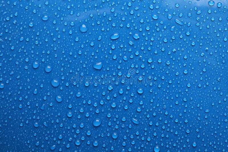 Вода падает на синий фон стоковое фото rf