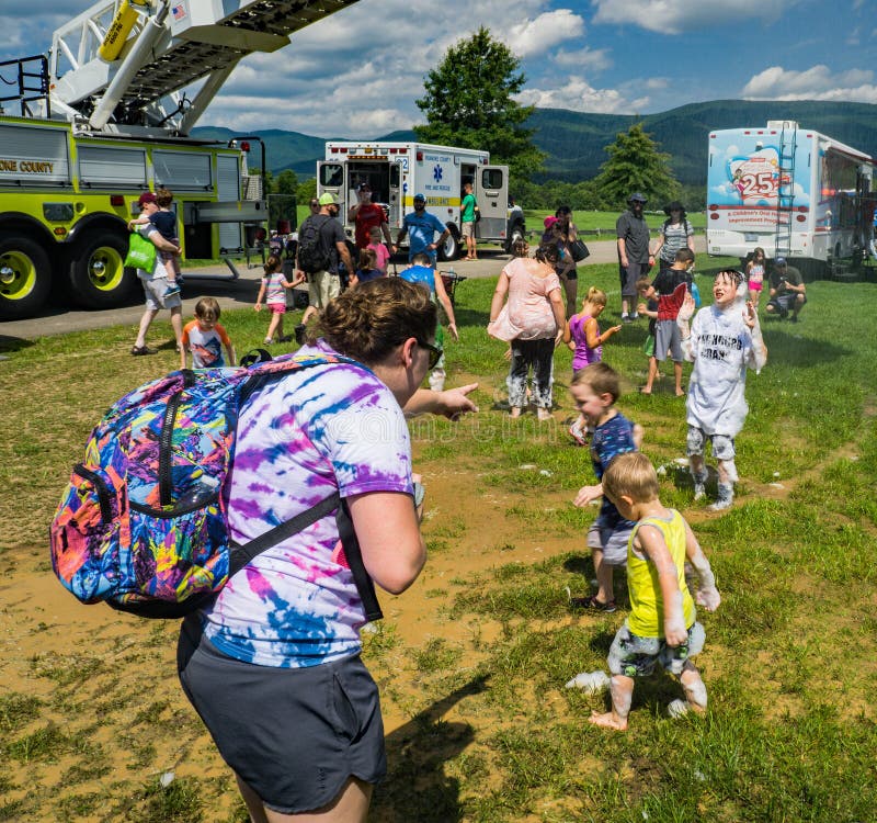 Salem, VA – July 28th: Fireman’s ladder truck spraying water as children play under the water spray located at the Annual Touch-A-Truck in Greenhill Park, Salem, Virginia, USA on July 28th, 2018. Salem, VA – July 28th: Fireman’s ladder truck spraying water as children play under the water spray located at the Annual Touch-A-Truck in Greenhill Park, Salem, Virginia, USA on July 28th, 2018.