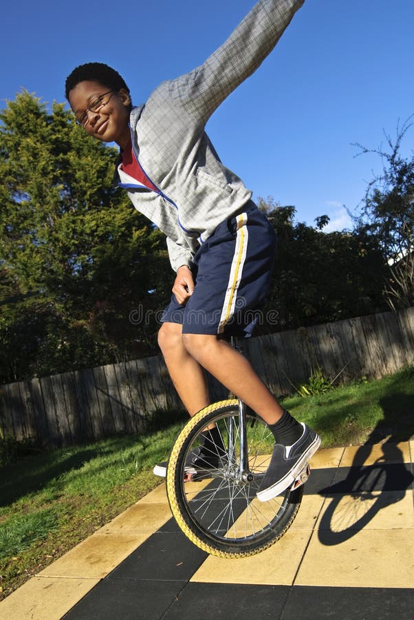 Airborne confident teenager on monocycle performing tricks. Airborne confident teenager on monocycle performing tricks