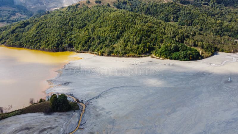 Aerial View Over a Big Waste Lake Polluted With Toxic Mining Residuals Tailings From an Open Pit Copper Mine in Geamana, Rosia Poieni, Romania. Aerial View Over a Big Waste Lake Polluted With Toxic Mining Residuals Tailings From an Open Pit Copper Mine in Geamana, Rosia Poieni, Romania