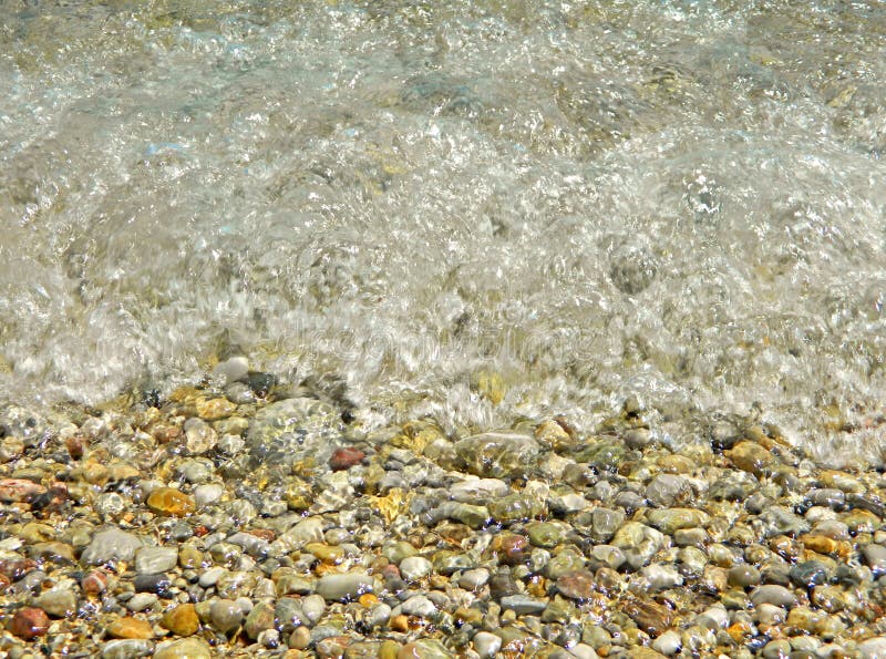 A sea wave hits the colorful rocks on the beach. Herceg Novi, in Montenegro, Adriatic sea. Ideal for poster or background. A sea wave hits the colorful rocks on the beach. Herceg Novi, in Montenegro, Adriatic sea. Ideal for poster or background.