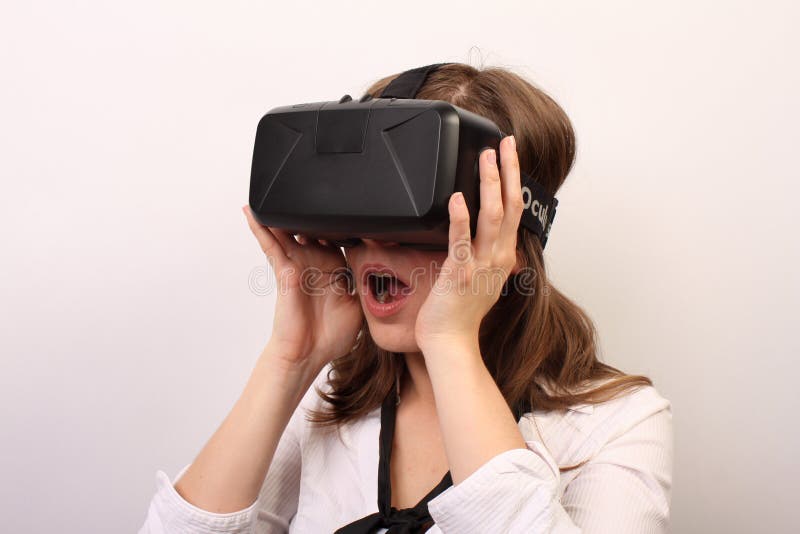 A woman wearing Oculus Rift virtual reality headset. She's impressed with the game, astonished, amused or flabbergasted. Maybe she disliked the game or saw something scary. Front view of the girl in a neutral pose with her tie visible. We can see the side portrait of the female wearing the Oculus game set on the forehead, holding it with her hands. Formal outfit makes the woman look professional and formal. Might have been watching a 3d movie, observing something in an immersive game, playing. Horizontal studio portrait with a white background. She looks dazzled, impressed, astounded, astonished, maybe positively shocked. A woman wearing Oculus Rift virtual reality headset. She's impressed with the game, astonished, amused or flabbergasted. Maybe she disliked the game or saw something scary. Front view of the girl in a neutral pose with her tie visible. We can see the side portrait of the female wearing the Oculus game set on the forehead, holding it with her hands. Formal outfit makes the woman look professional and formal. Might have been watching a 3d movie, observing something in an immersive game, playing. Horizontal studio portrait with a white background. She looks dazzled, impressed, astounded, astonished, maybe positively shocked.