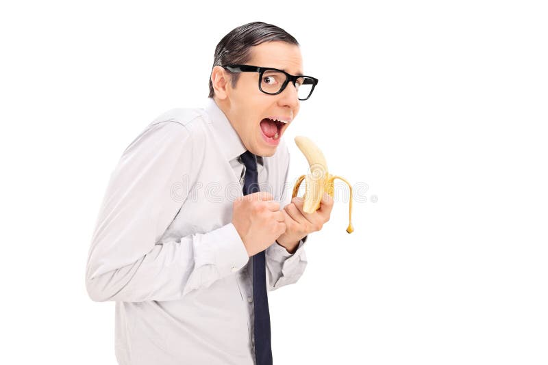 Scared man with glasses eating a banana isolated on white background. Scared man with glasses eating a banana isolated on white background