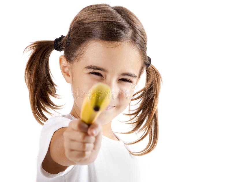 Little girl isolated on white pretending is shoot with a banana. Little girl isolated on white pretending is shoot with a banana