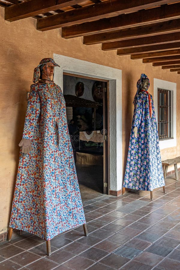 Guatemala, La Antigua - July 20, 2023: Finca La Azotea museums. Entrance to traditional dress exhibition with 2 tall dressed-up mannequins. Guatemala, La Antigua - July 20, 2023: Finca La Azotea museums. Entrance to traditional dress exhibition with 2 tall dressed-up mannequins