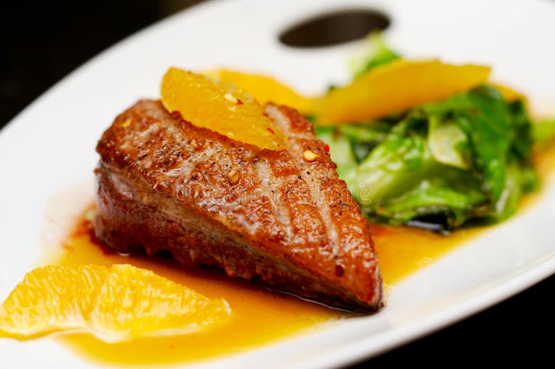 Roasted duck breast fillet with miso-orange sauce and fried bokchoy. Roasted duck breast fillet with miso-orange sauce and fried bokchoy