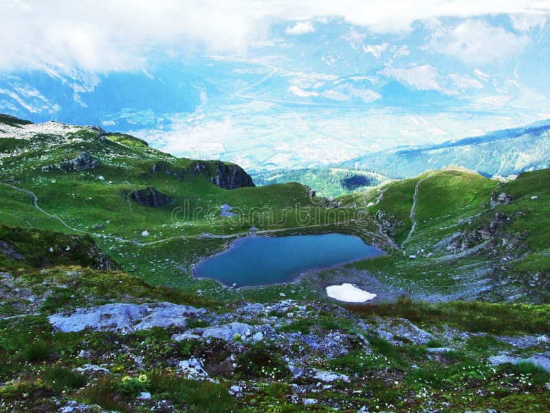 Alpine Lake Baschalvasee under the Pizol peak in the mountain range Glarus Alps - Canton of St. Gallen, Switzerland. Alpine Lake Baschalvasee under the Pizol peak in the mountain range Glarus Alps - Canton of St. Gallen, Switzerland