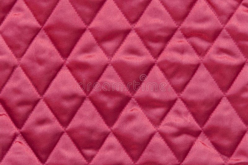 Close up of quilted christmas tree skirt fabric in traditional red color. Close up of quilted christmas tree skirt fabric in traditional red color