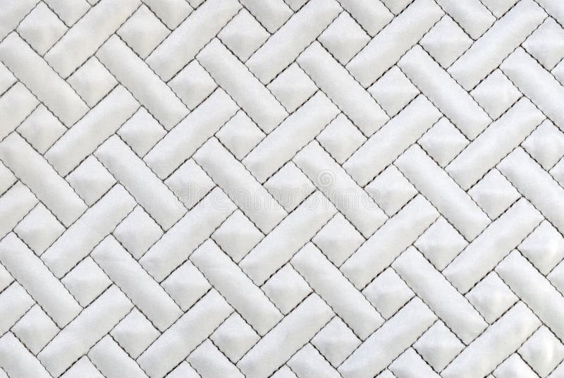 Close up of white quilted background. Close up of white quilted background.