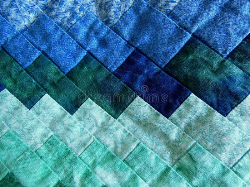 Quilted pieces of fabric in beautiful different shades of blue and green colors. Quilted pieces of fabric in beautiful different shades of blue and green colors.