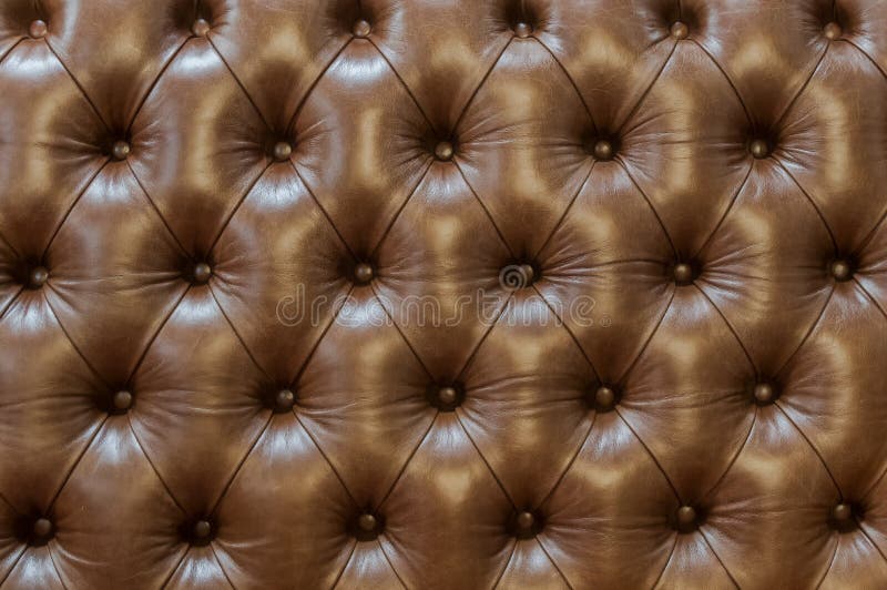 Fragment of brown leather backrest upholstery quilted buttons. Fragment of brown leather backrest upholstery quilted buttons.