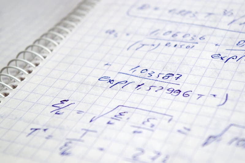 Hand written maths calculations on the exercise book. Hand written maths calculations on the exercise book