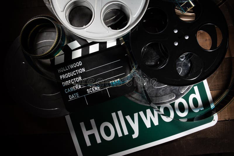 Вьюрок фильма и clapboard Голливуд, предпосылка индустрии развлечений на деревянной таблице стоковая фотография Вьюрок фильма и clapboard Голливуд, предпосылка индустрии развлечений на деревянной таблице стоковая фотография