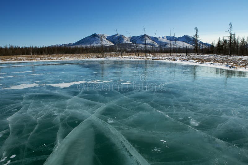 Deep ice on a lake in the cracks. Yakutia. Russia. Deep ice on a lake in the cracks. Yakutia. Russia.