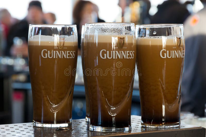 DUBLIN, IRELAND - FEB 15, 2014: Pints of beer are served at the popular Guinness Brewery on Feb 15, 2014. The brewery where 2.5 million pints of stout are brewed daily was founded by Arthur Guinness in 1759. DUBLIN, IRELAND - FEB 15, 2014: Pints of beer are served at the popular Guinness Brewery on Feb 15, 2014. The brewery where 2.5 million pints of stout are brewed daily was founded by Arthur Guinness in 1759.