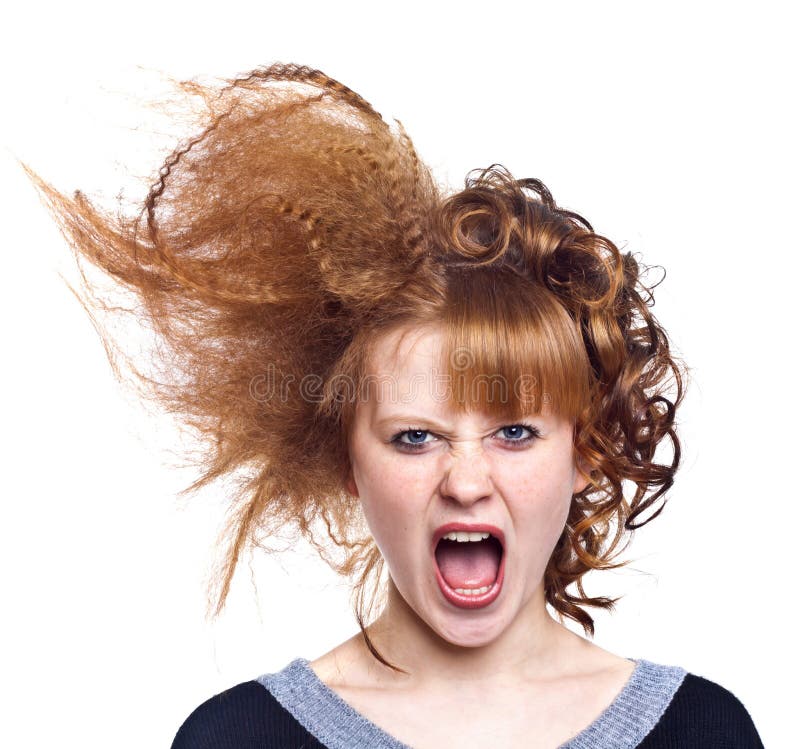 Portrait of the indignant young woman on the isolated white background.Strange hairdress. Anger. Portrait of the indignant young woman on the isolated white background.Strange hairdress. Anger