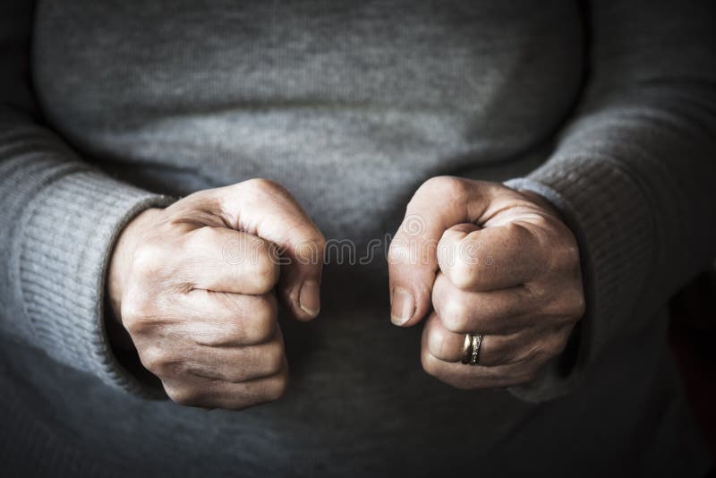 The fists of an old woman strongly closed because of anger - black and white image. The fists of an old woman strongly closed because of anger - black and white image