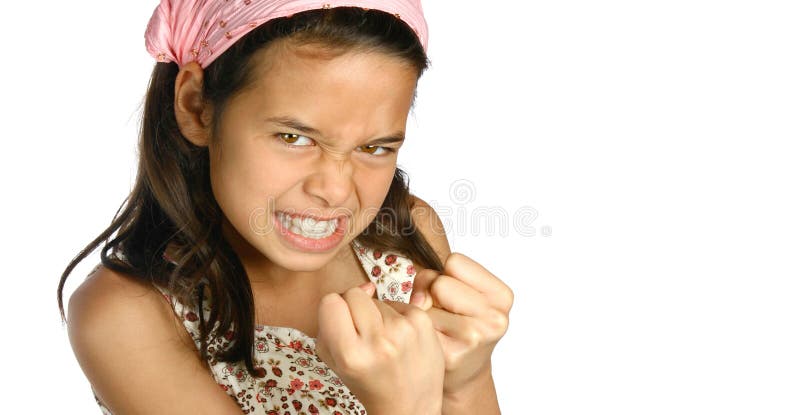 Young girl baring her teeth and showing both hands in fist, in an expression of anger and frustration, isolated. Young girl baring her teeth and showing both hands in fist, in an expression of anger and frustration, isolated.