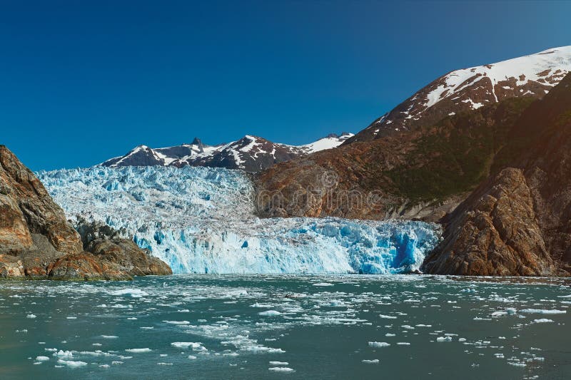 Blue glacier in mountain landscape. Travel destination in Alaska. Tracy Arm glacier tour. Blue glacier in mountain landscape. Travel destination in Alaska. Tracy Arm glacier tour