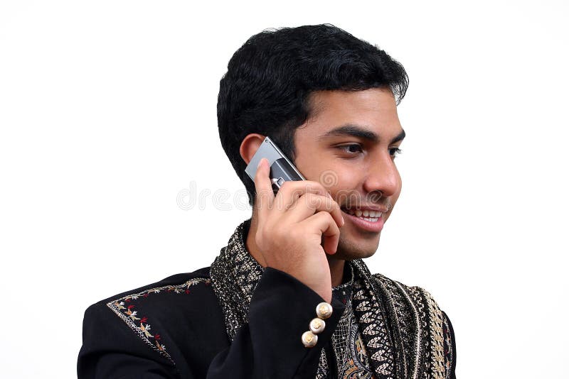 Indian in traditional clothes speaking in the phone (2) with clipping path. Indian in traditional clothes speaking in the phone (2) with clipping path