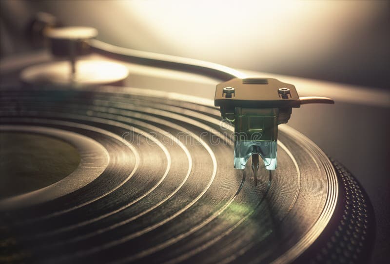 Vinyl record being played on old retro vintage disc jockey device. Vinyl record being played on old retro vintage disc jockey device.