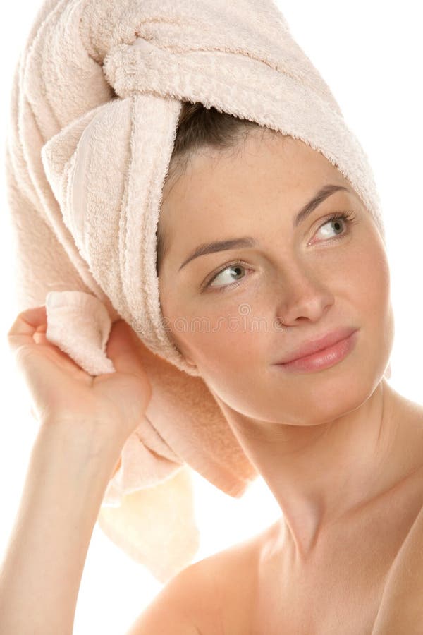 Portrait of young woman with head wrapped towel isolated on white background. Portrait of young woman with head wrapped towel isolated on white background