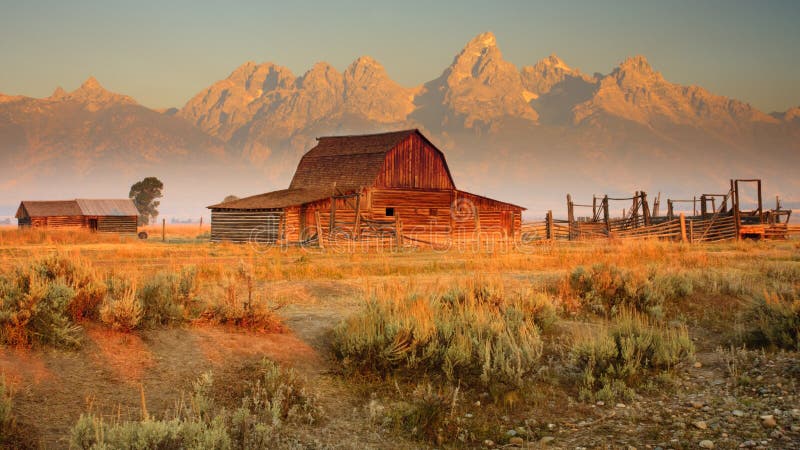 Old barn sits in front of the Grand Teton Mountains, Wyoming. Old barn sits in front of the Grand Teton Mountains, Wyoming.