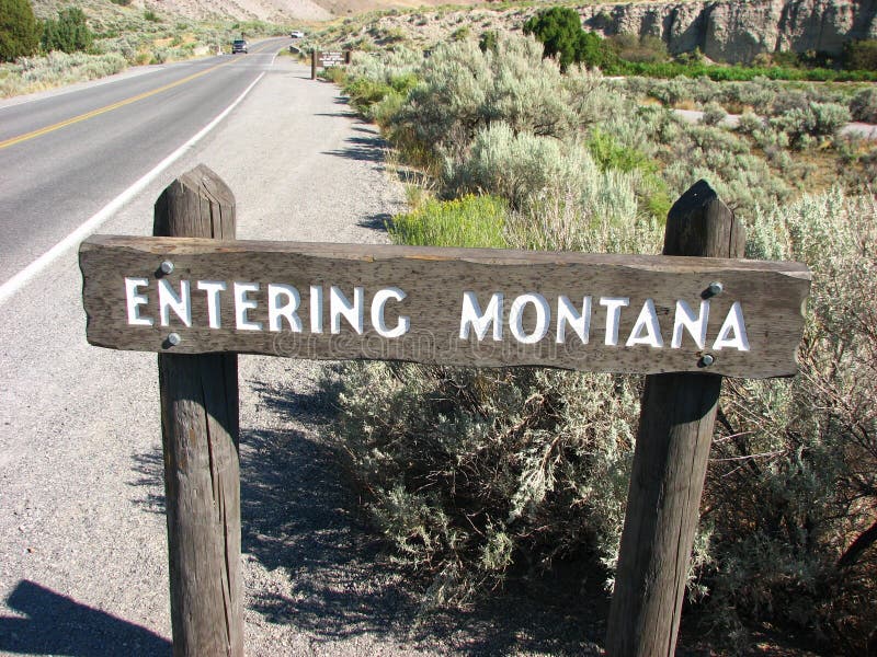 Entering Montana State wooden sign close to Boiling River north of Mammoth Hot Springs, Yellowstone National Park, Wyoming, USA. Entering Montana State wooden sign close to Boiling River north of Mammoth Hot Springs, Yellowstone National Park, Wyoming, USA