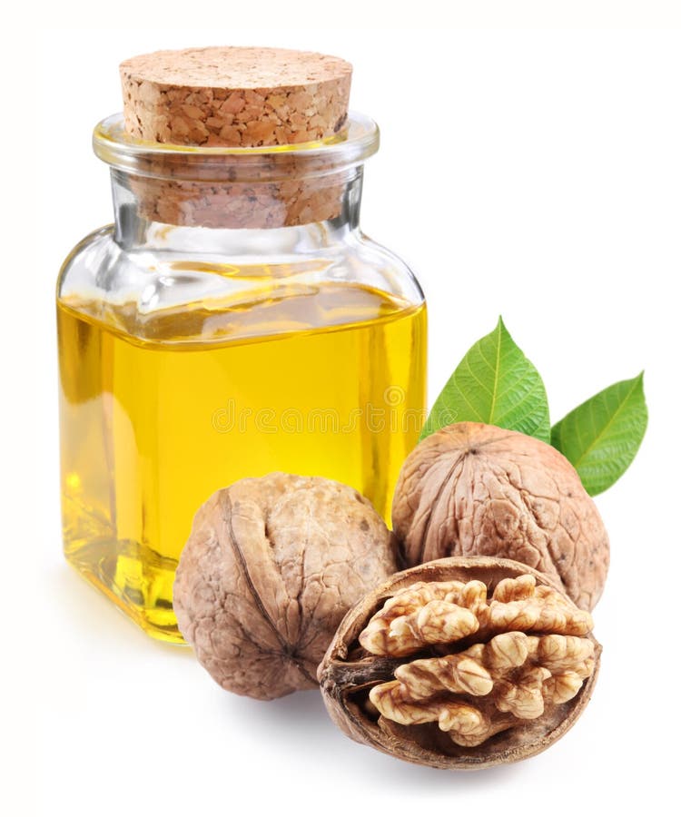 Walnut oil and nuts on white background. Walnut oil and nuts on white background.