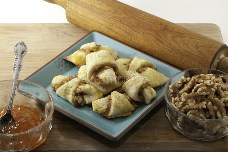 Apricot Walnut Rugelach on a plate with walnuts and preserves. Apricot Walnut Rugelach on a plate with walnuts and preserves.