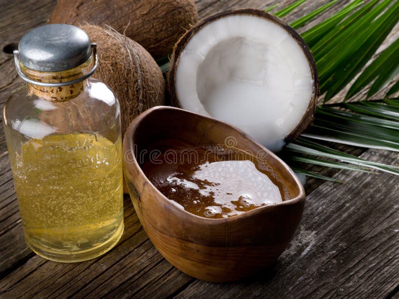 Natural coconut walnut oil on wood background. Natural coconut walnut oil on wood background