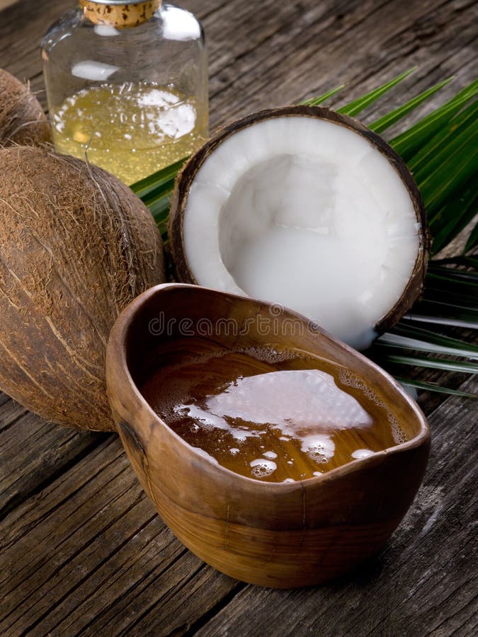 Natural coconut walnut oil on wood background. Natural coconut walnut oil on wood background