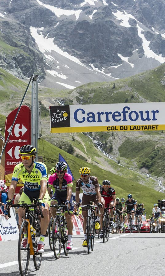 Col du Lautaret, France - July 19, 2014: Group of cyclists ( Nicolas Roche-Tinkoff-Saxo, José Serpa- Lampre-Merida, Christophe Riblon-Ag2r-La Mondiale ) arrived first on mountain pass Lautaret during the stage 14 of Le Tour de France 2014. Col du Lautaret, France - July 19, 2014: Group of cyclists ( Nicolas Roche-Tinkoff-Saxo, José Serpa- Lampre-Merida, Christophe Riblon-Ag2r-La Mondiale ) arrived first on mountain pass Lautaret during the stage 14 of Le Tour de France 2014.