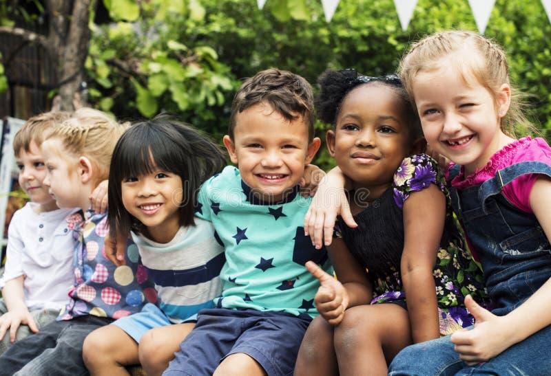 Group of kindergarten kids friends arm around sitting and smiling fun. Group of kindergarten kids friends arm around sitting and smiling fun