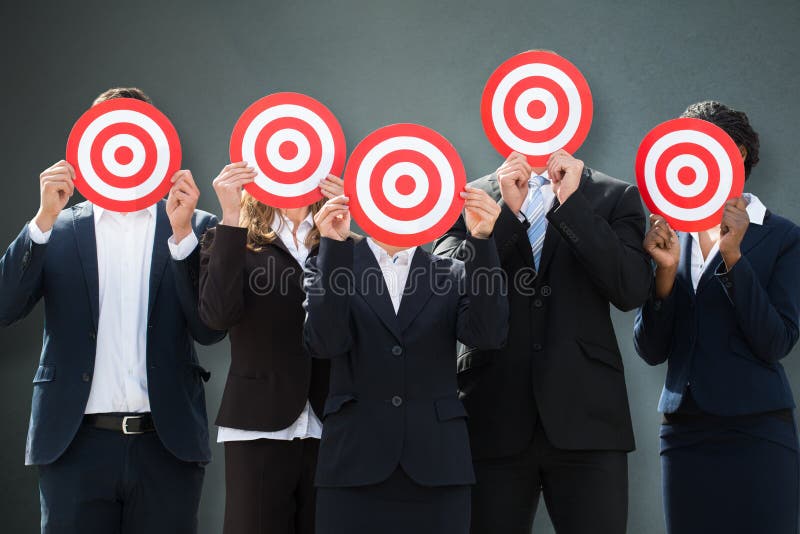 Группа в составе предприниматели пряча их стороны за Dartboard стоковая фотография rf Группа в составе предприниматели пряча их стороны за Dartboard стоковая фотография rf