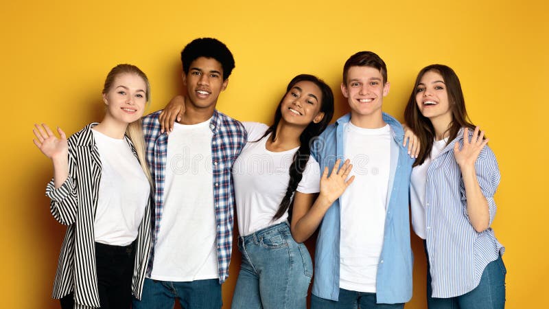 A group of multiethnic teenagers are standing next to each other, facing the camera. They are casually dressed and appear to be engaged in conversation or posing for a picture. A group of multiethnic teenagers are standing next to each other, facing the camera. They are casually dressed and appear to be engaged in conversation or posing for a picture.