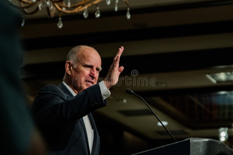 California Governor Edmund G. Brown Jr. waves to audience attendees at the 2016 SEJ Conference (Society of Environmental Journalists) hotel ballroom dining dinner chandelier room hall evening. California Governor Edmund G. Brown Jr. waves to audience attendees at the 2016 SEJ Conference (Society of Environmental Journalists) hotel ballroom dining dinner chandelier room hall evening